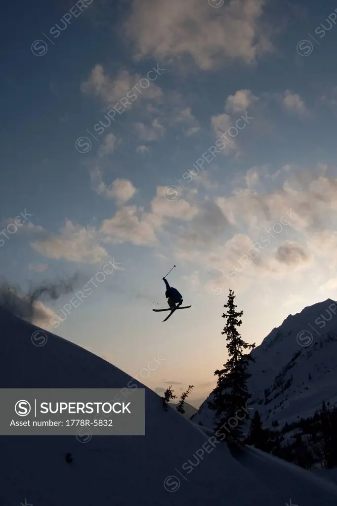 Skier in mid_air at sunset in Utah.