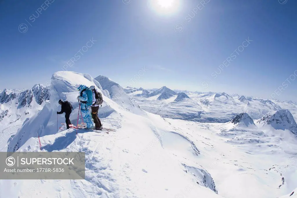 Two skiers look down an exposed ridge in Valdez, Alaska.