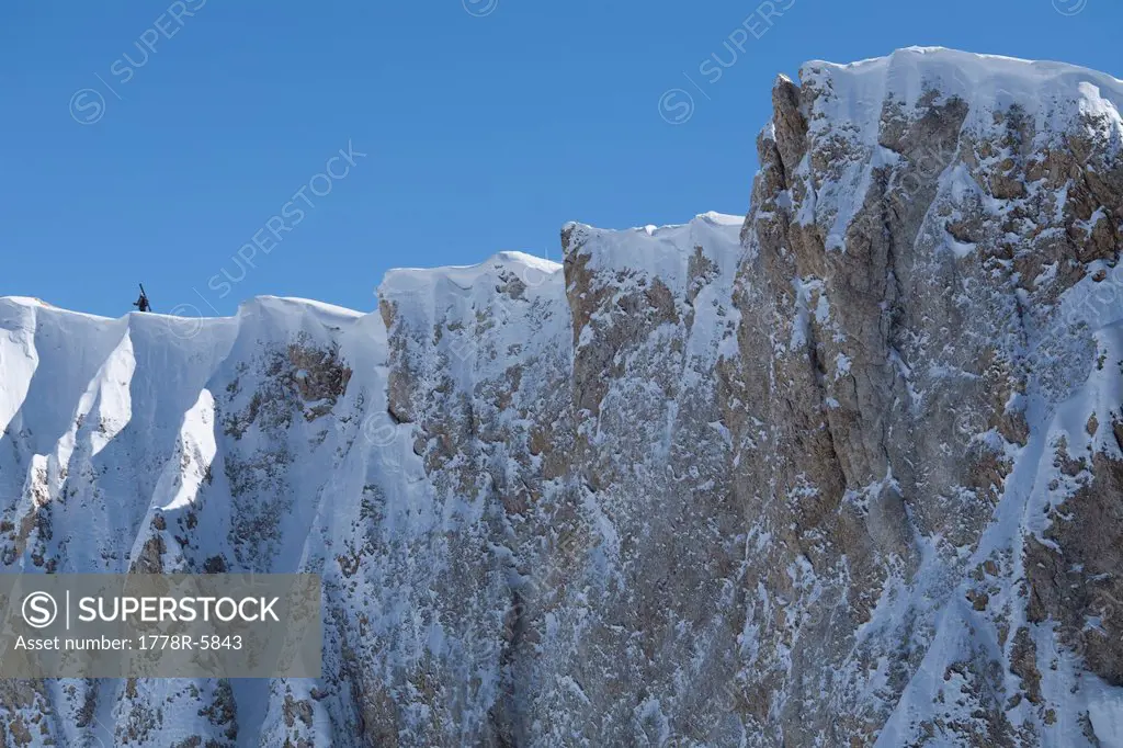 A lone skier hiking on an exposed ridge, Las Lenas, Argentina.