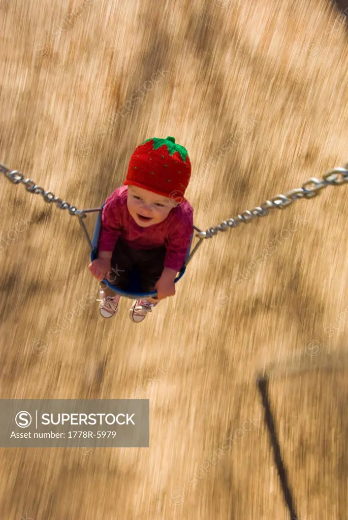 Toddler in swing at town park, Durango, Colorado blurred motion.