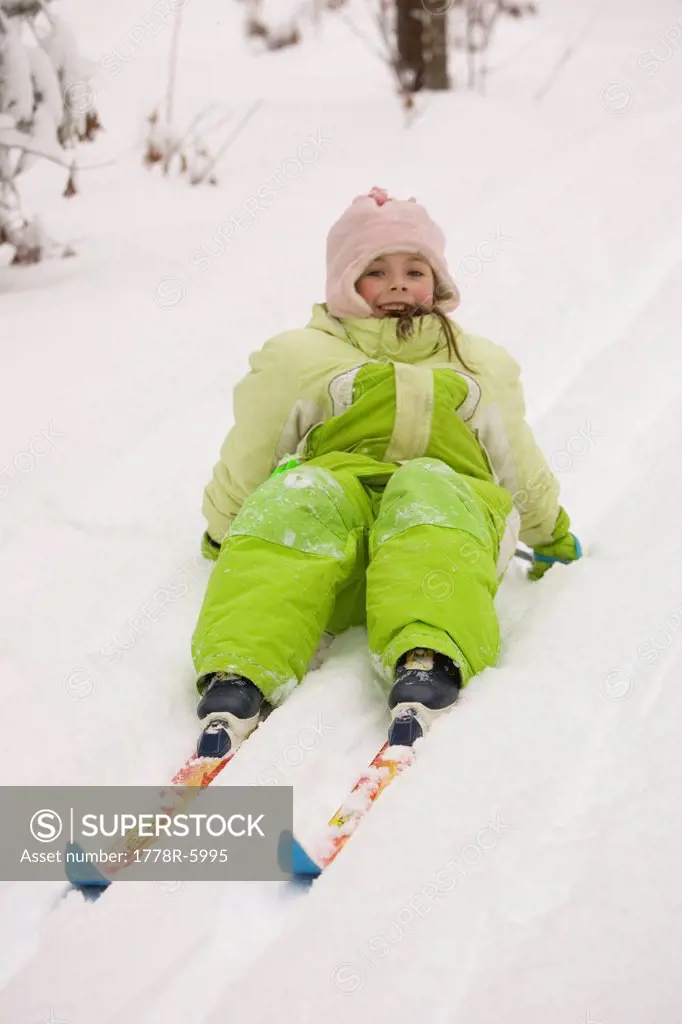 A young girl attempts to get up, while Cross Country Skiing in Dayton, Maine.