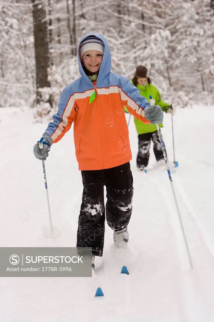 Two young girls Cross Country Skiing in Dayton, Maine.