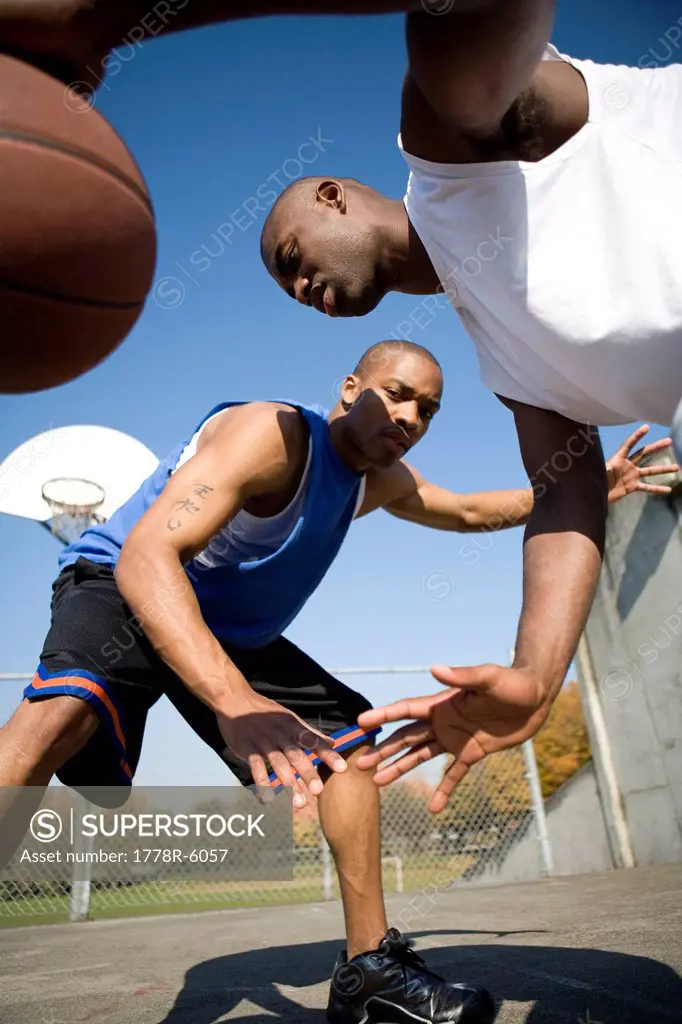 Two men play basketball in Portland, Oregon.