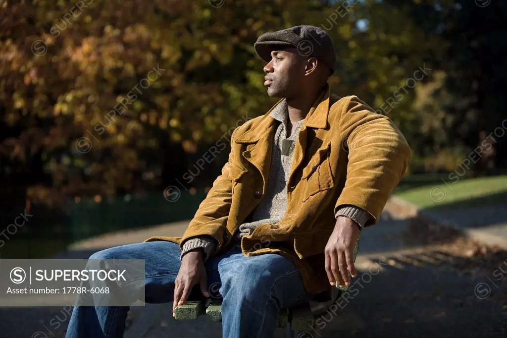 Man of African ethnicity sits on park bench in Portland, Oregon.