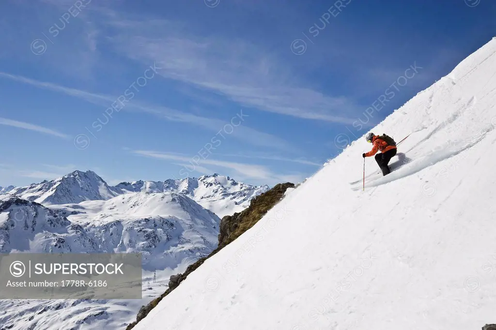 A young man skis down a steep slope at St. Anton am Arlberg, Austria.