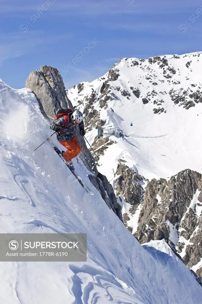 A young man skis on a steep slope in St. Anton am Arlberg, Austria.