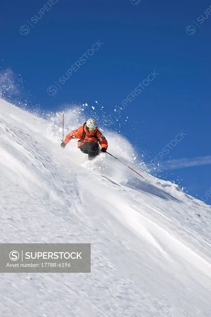 A young man skis untracked powder off_piste at St. Anton am Arlberg, Austria.