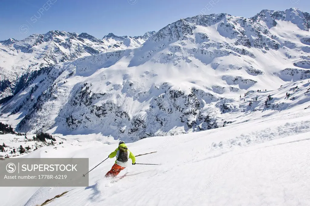 A young man skis untracked powder off_piste at St. Anton am Arlberg, Austria.