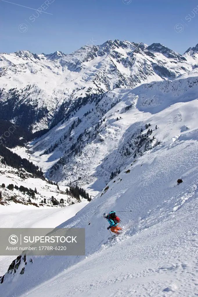 A young man catches air while skiing off_piste near St. Anton am Arlberg, Austria.