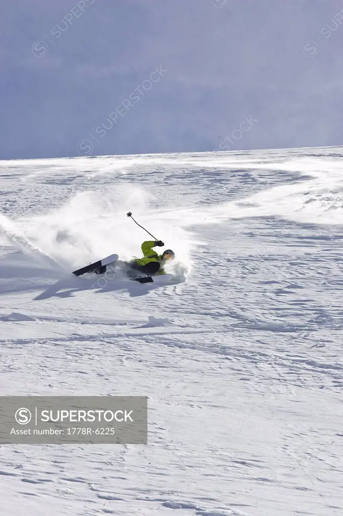 A young man falls while skiing untracked powder off_piste at the Stubai Ski Resort, near Innsbruck, Austria.