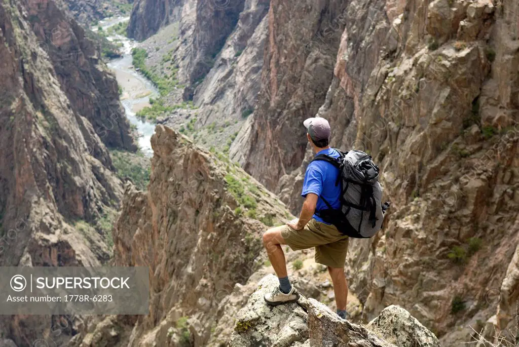 Man hiking on the North Rim of the Black Canyon of the Gunnison, Colorado.