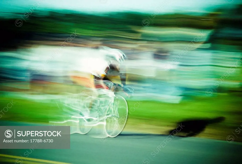 One man racing a bicycle blurred motion.