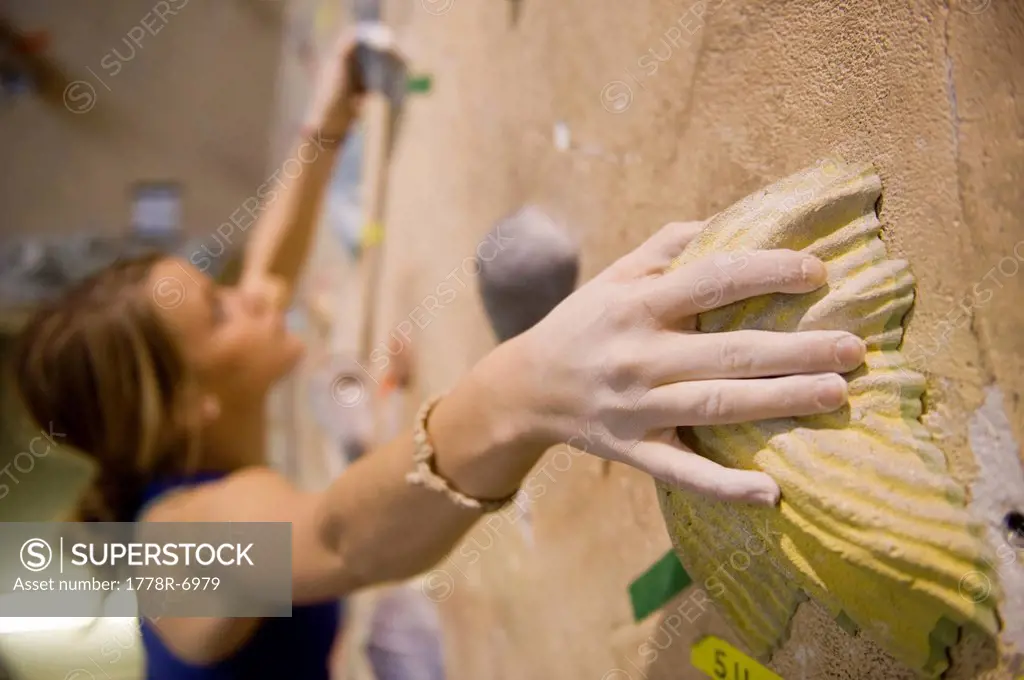 A woman rock climbing indoors at Estes Park, Colorado.