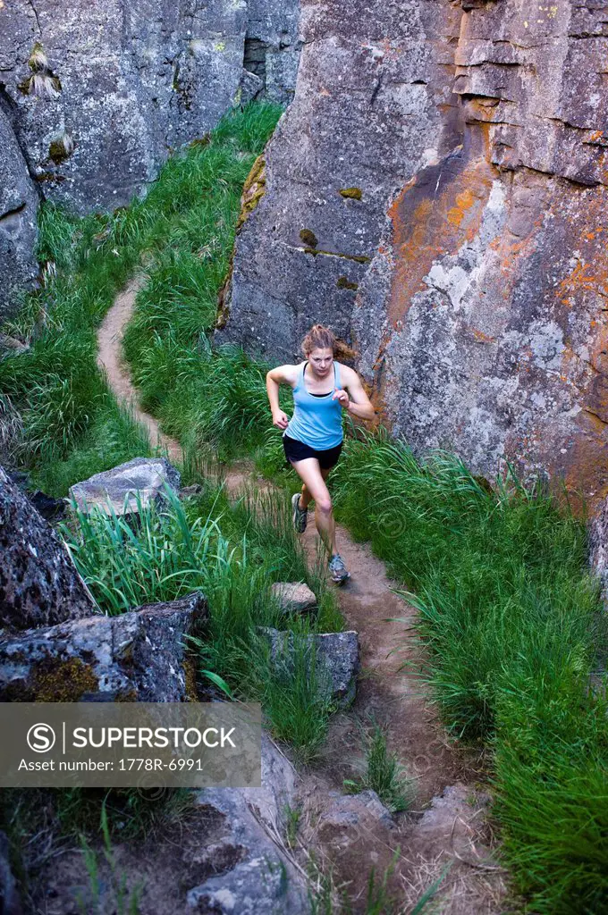 One woman running through Crack In the Ground, a volcanic fissure near Christmas Valley, Oregon.