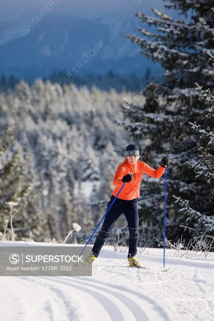 A young woman cross_country skiing.