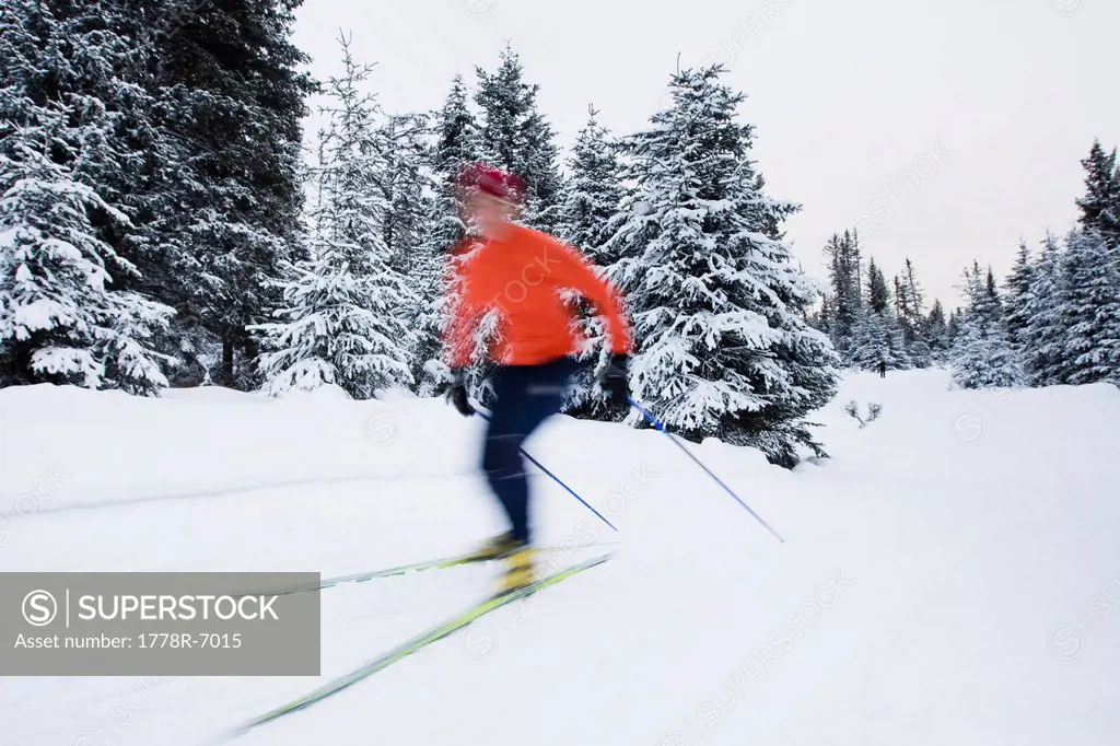 A young woman cross_country skiing. blurred motion.