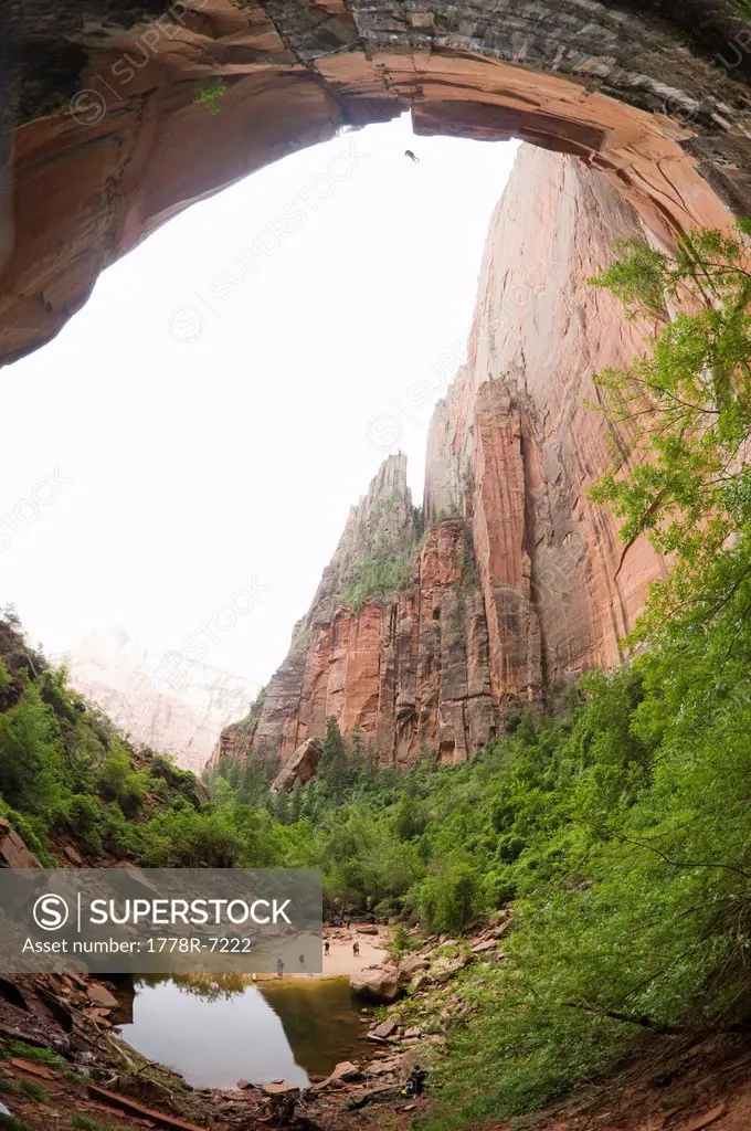 A canyoneering man completing a free rappel at the end of Heaps Canyon, Zion National Park, Springdale, Utah.