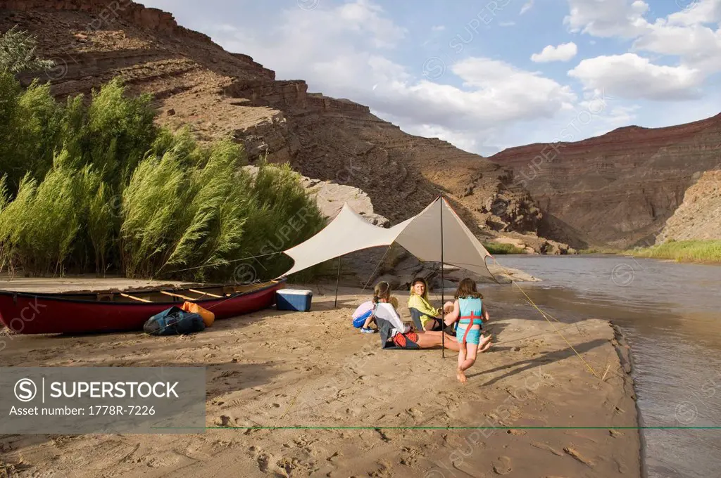 Two young girls playing near their mothers while camping on the San Juan River, Mexican Hat, Utah.
