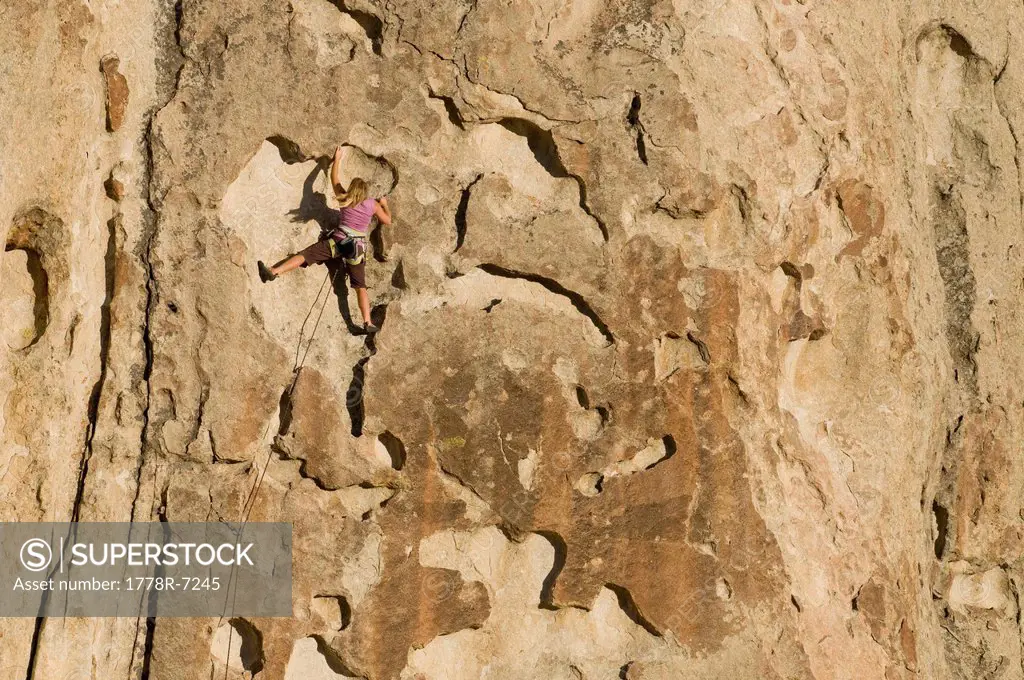 A woman rock climbing in the City of Rocks National Reserve, Almo, Idaho.
