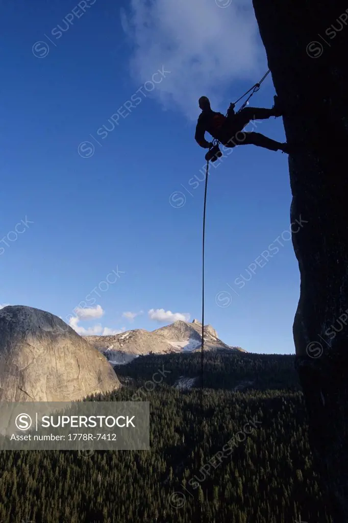 Climber rappelling of of Daff Dome, Tuolumne Meadows, Yosemite National Park, California.
