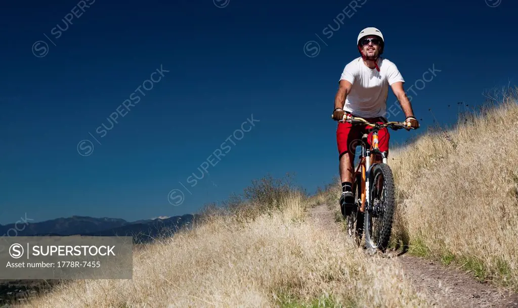 A male mountain biker pedals the trail on Mt. Sentinel, Missoula, Montana.
