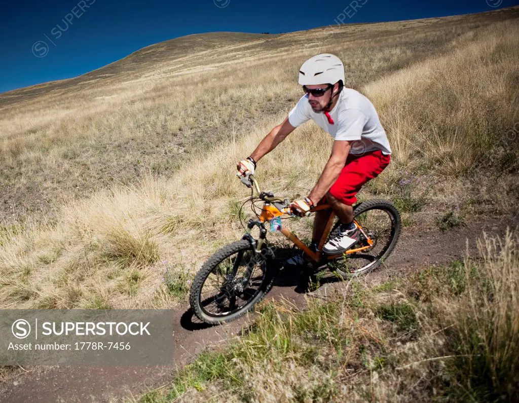 A male mountain biker pedals the trail on Mt. Sentinel, Missoula, Montana.