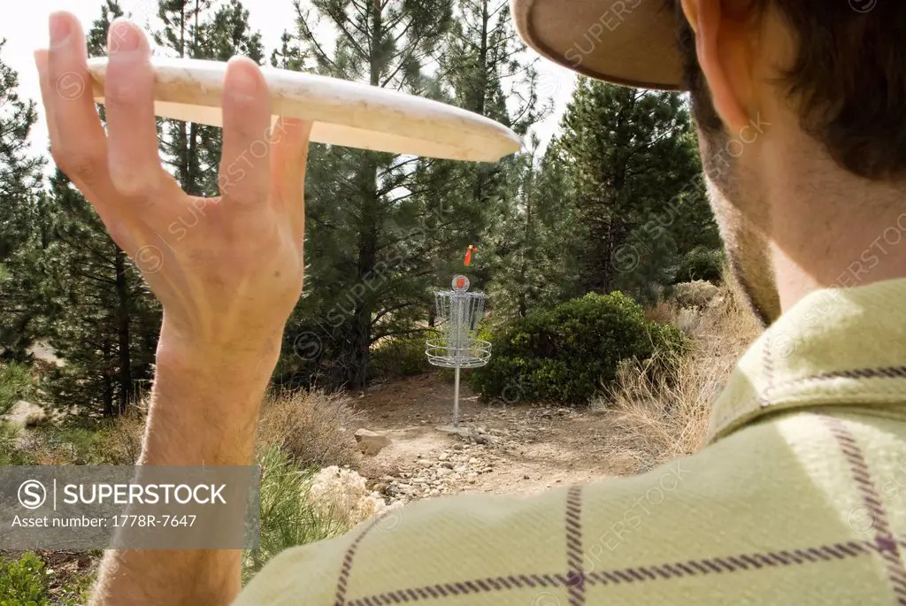 A young man perfects the pizza toss during a game of disc golf in Lake Tahoe, California.