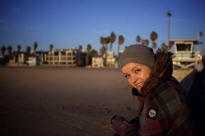 Smiling woman in knit hat looking at camera at Venice Beach, Los Angeles, California, USA