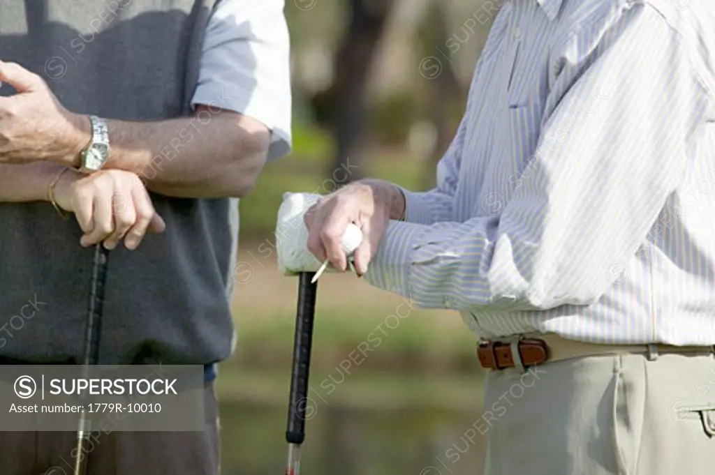 Senior men playing golf