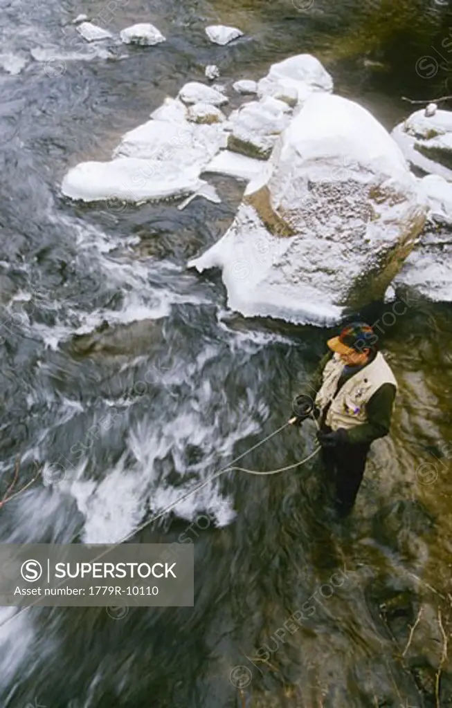 Overhead view of fly fisherman casting in stream