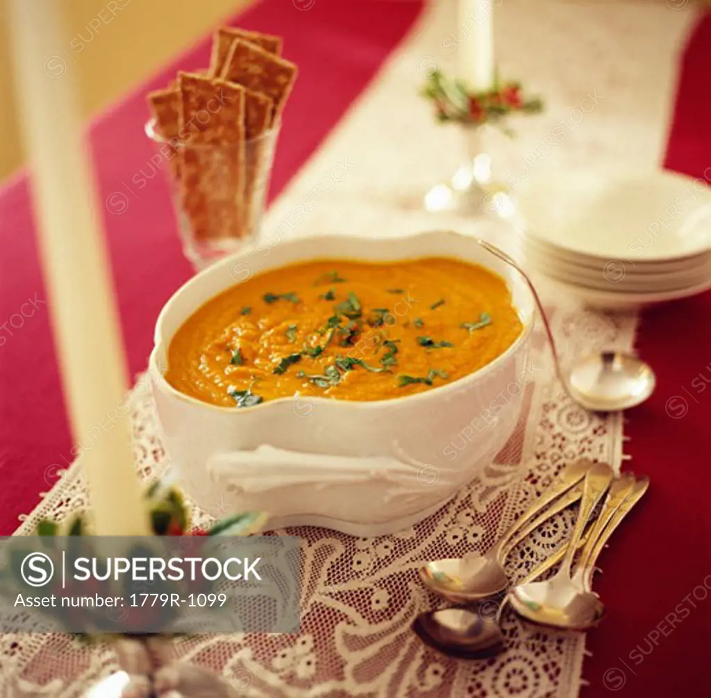 Serving dish of soup with crackers
