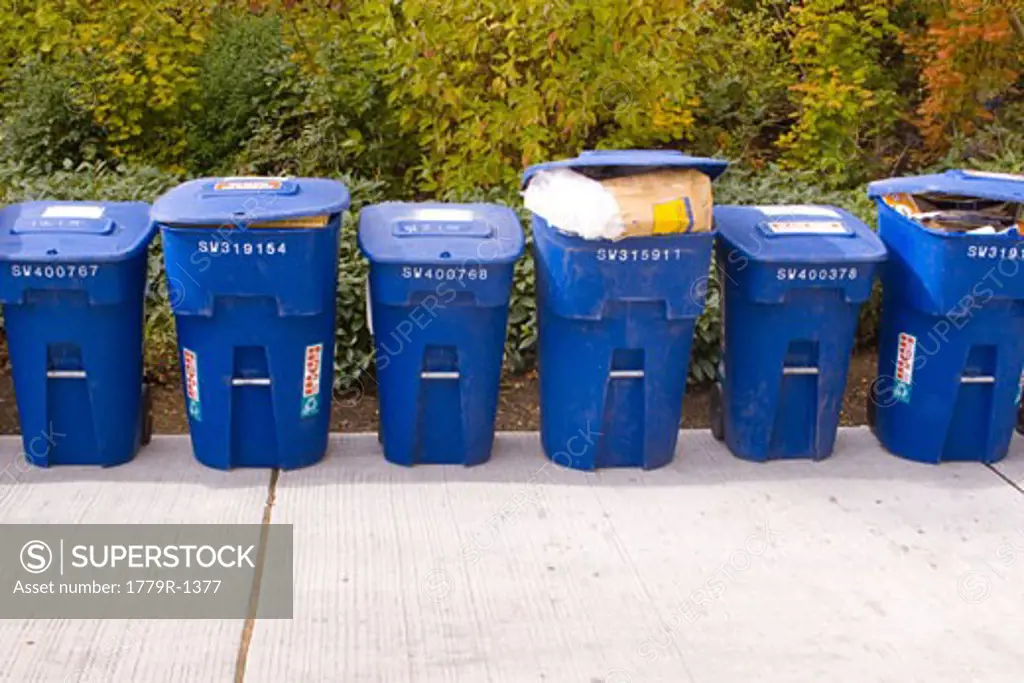 Row of full recycling bins