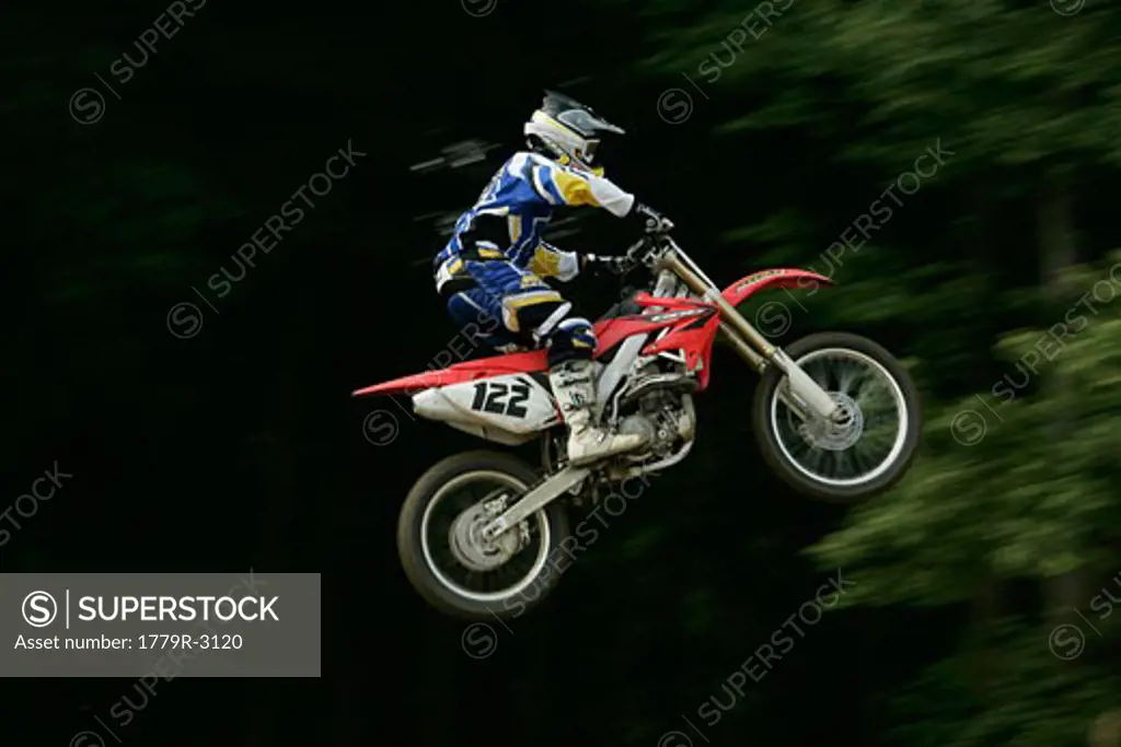 Motorcyclist jumping in mid-air