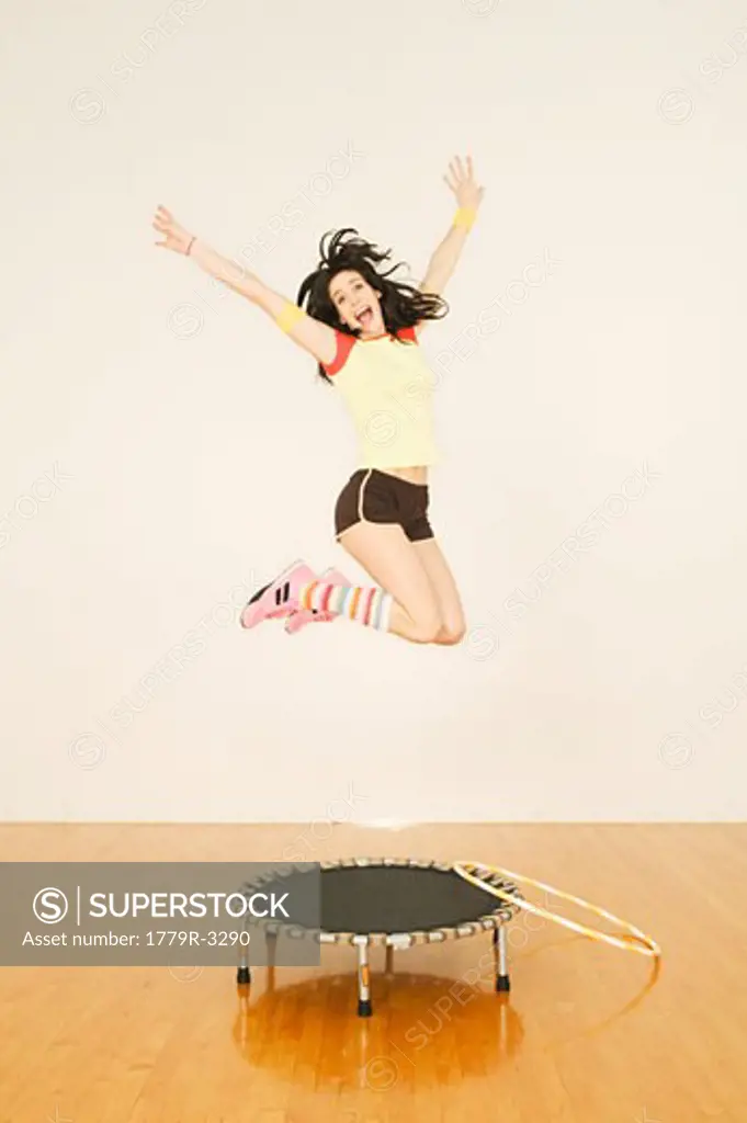 Woman in mid-air jumping on trampoline