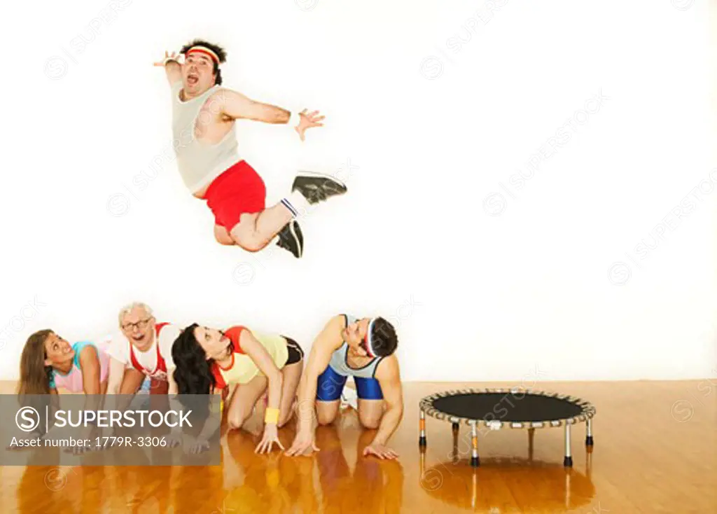 Man jumping over a line of other people
