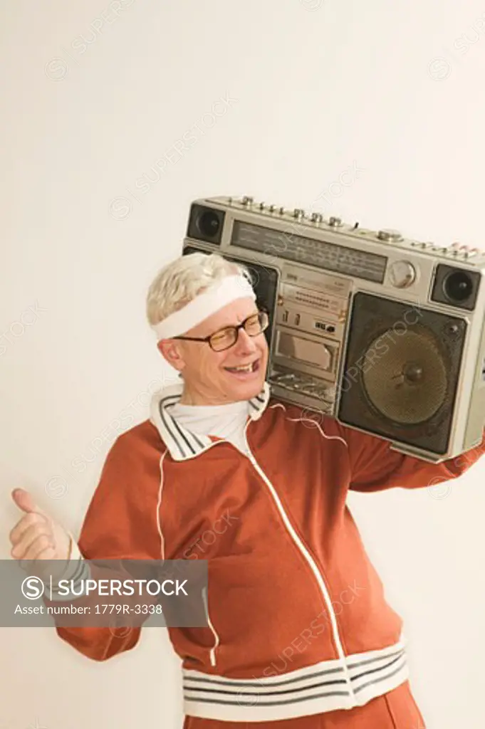 Senior man listening to boom box