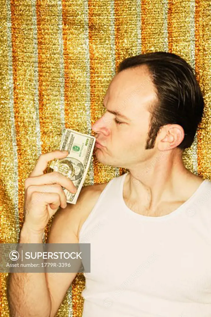 Man kissing dollar bills