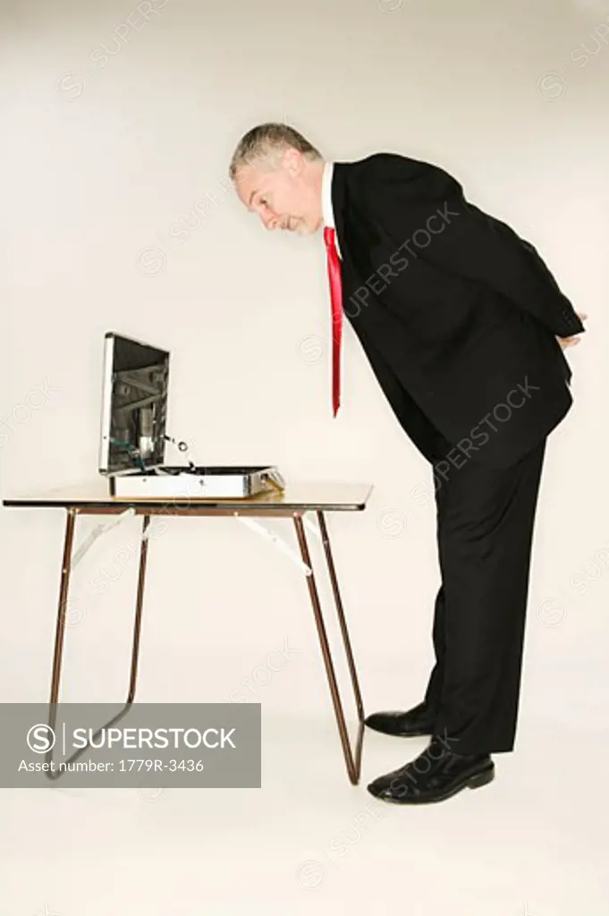 Businessman examining contents of briefcase