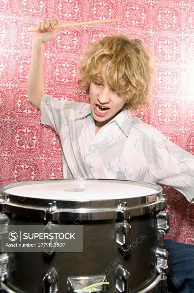 Young boy playing drums