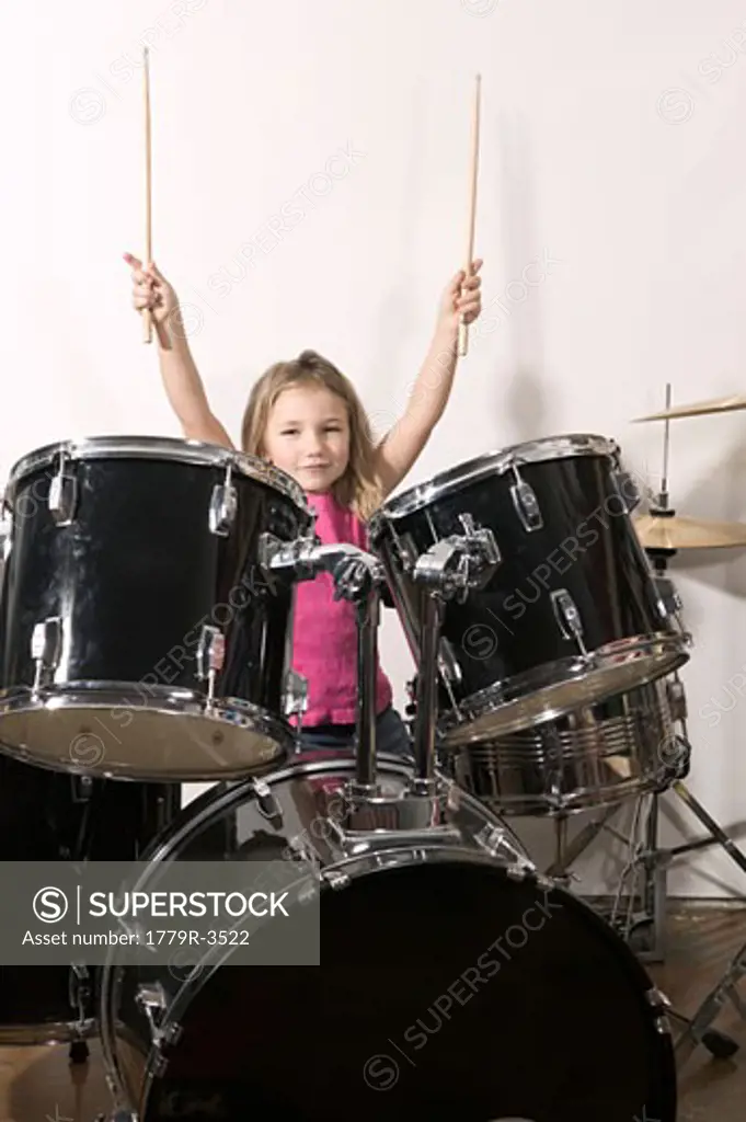 Young girl playing the drums