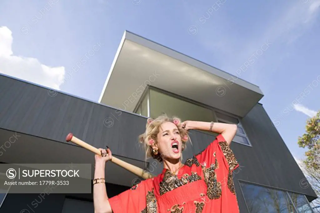 Woman in kimono swinging baseball bat