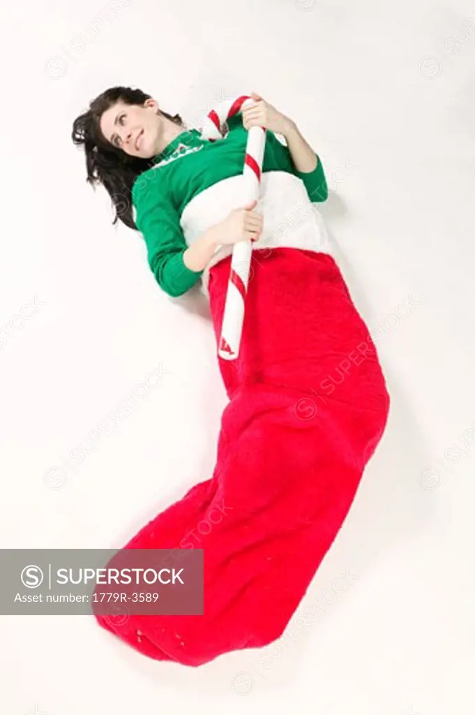 Woman laying inside in large Christmas stocking