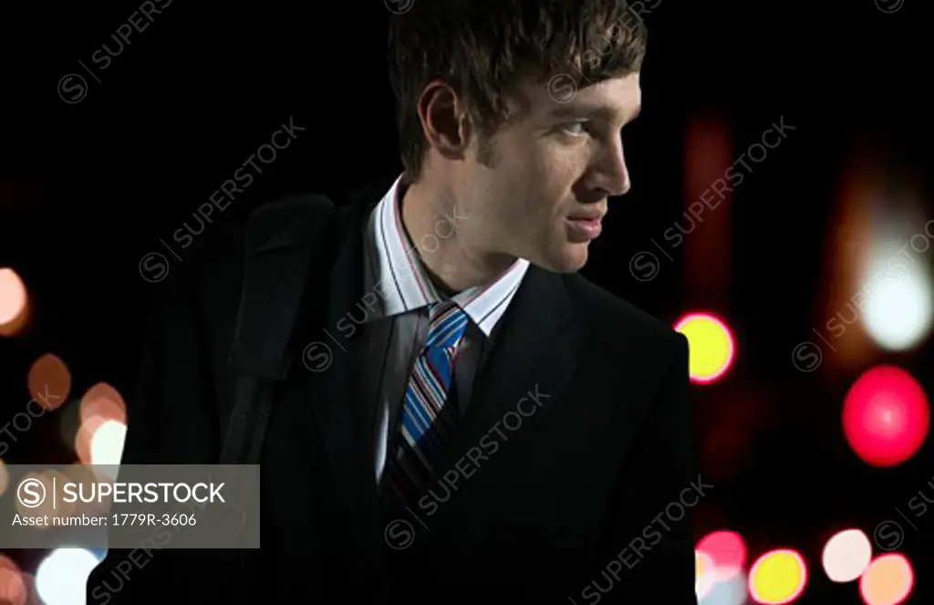 Businessman outdoors at night