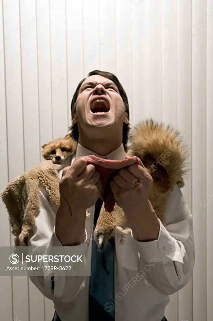 Shouting businessman in fur wrap and holding cut of meat