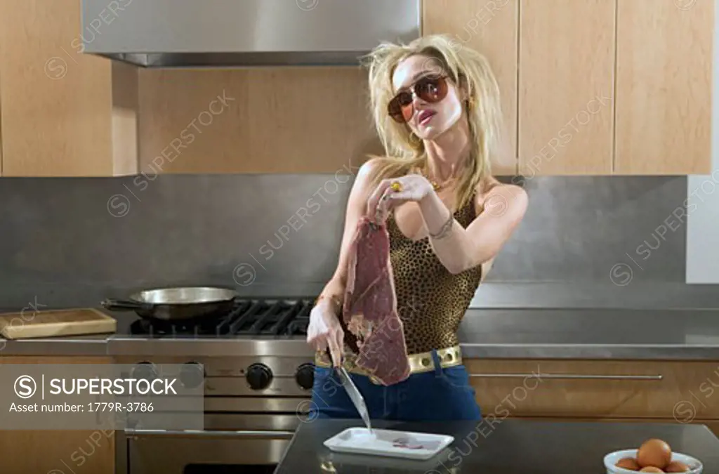 Glamorous woman delicately cutting meat
