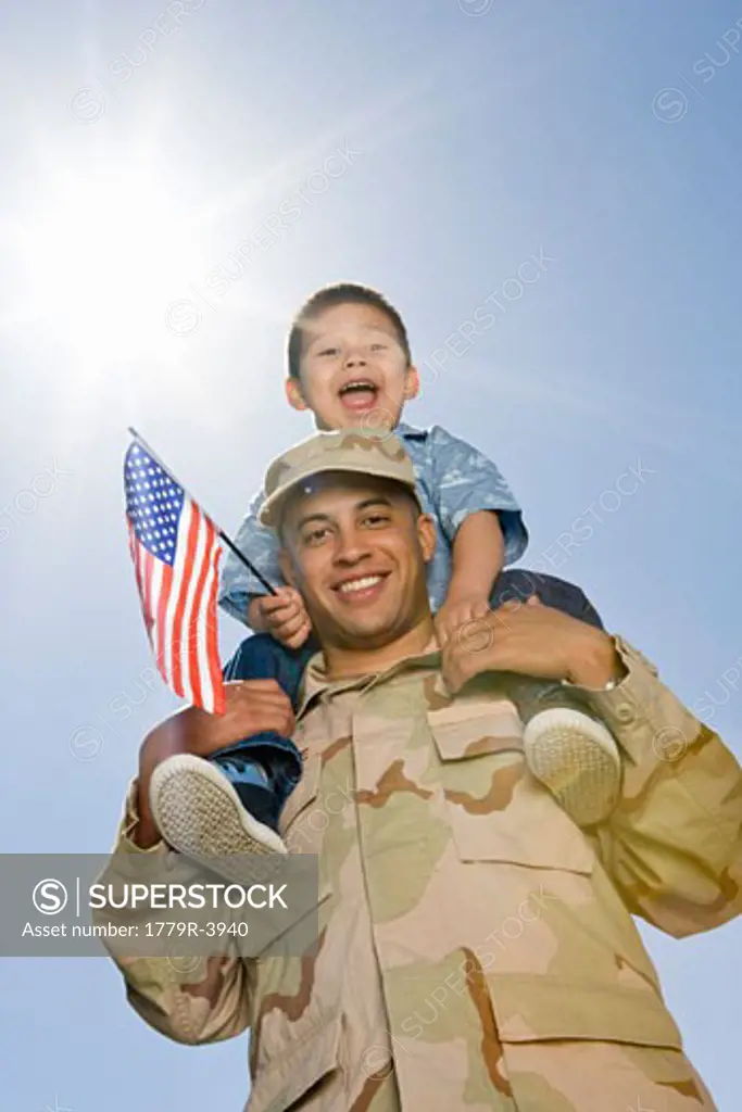 Military soldier holding son on shoulders