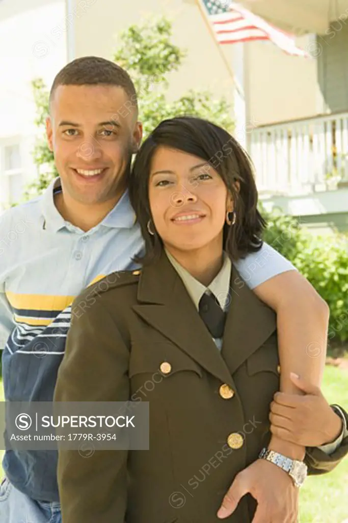 Hispanic military soldier and husband hugging