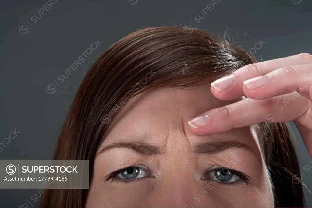 Young woman examining wrinkles