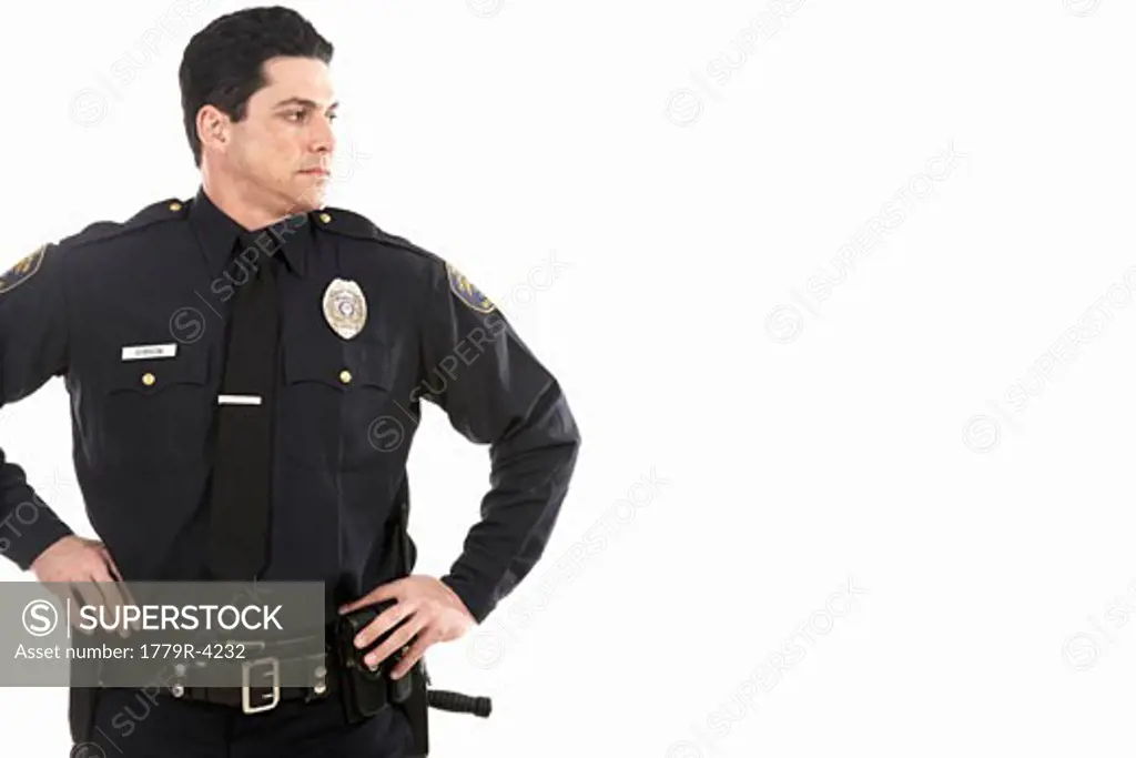 Male police officer standing with hands on hips