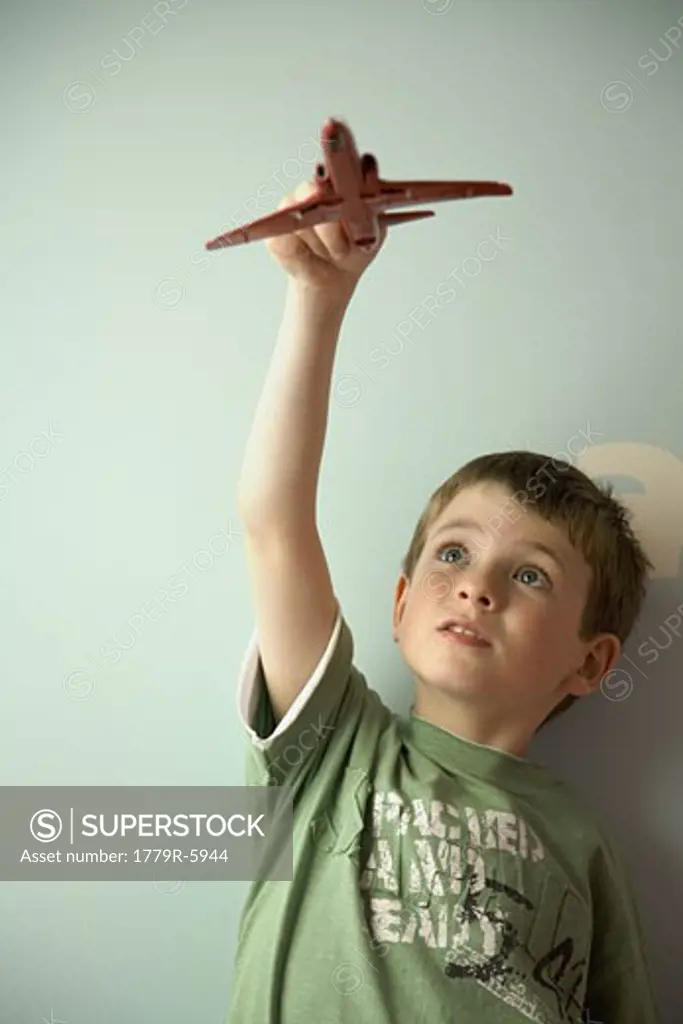 Boy flying toy airplane